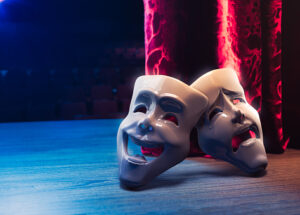 Theater masks, drama and comedy with a red curtain as backdrop / 3D Rendering, Mixed media.